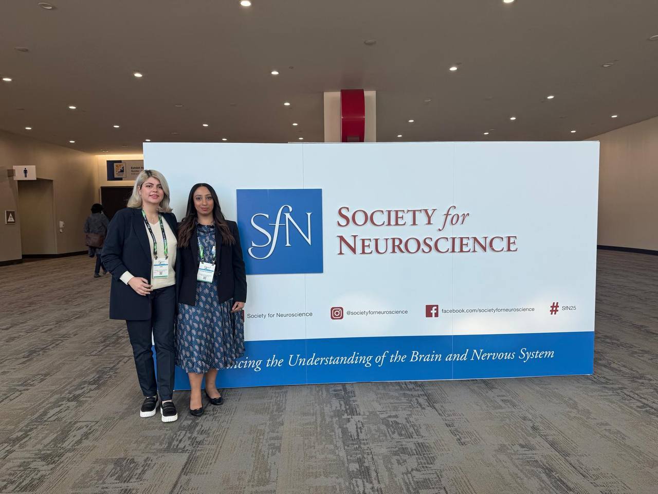 Sima and Danah in front of post