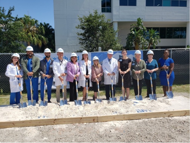 A group standing in hard hats and holding shovels for the groundbreaking of Kolschowsky Research and Education Institute