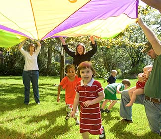 kids playing under parachute