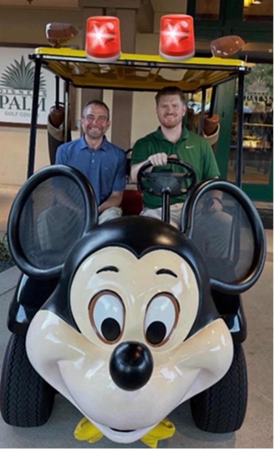 Program director and fellow in a mickey mouse golf cart