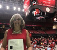 Danforth holding Distinguished Alumni Award