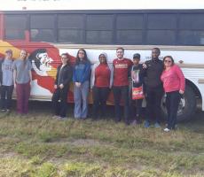 group picture in front of bus