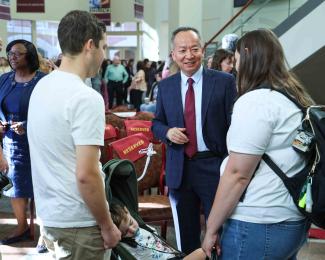 Research Associate Dean Xie with George family