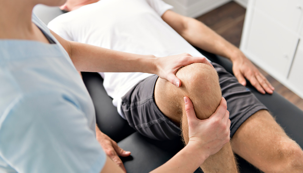 Doctor working on patient's knee