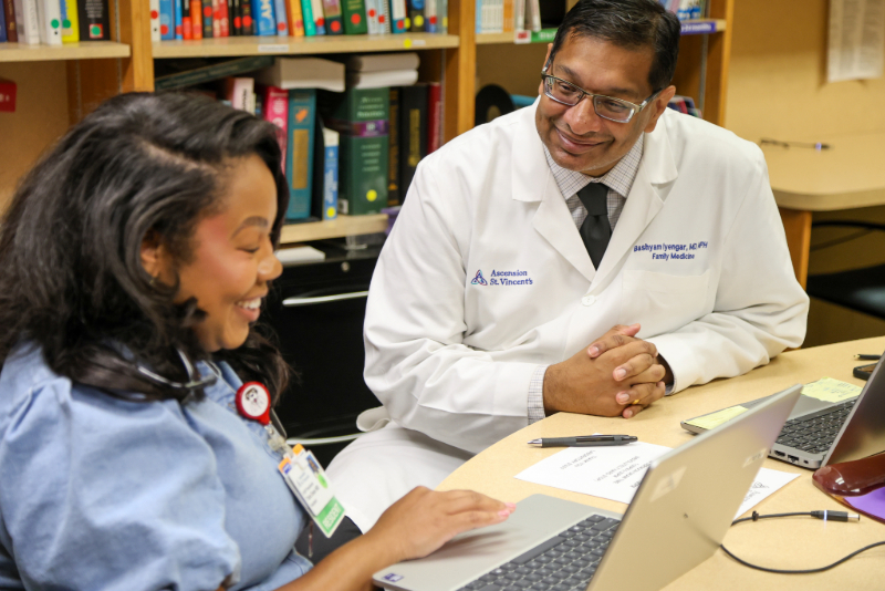 A student studies with a mentor