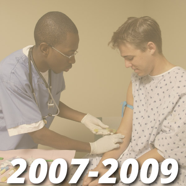 Timeline from 2007-2009, image shows a male college student in scrubs drawing blood from another male college student inside a mock clinical medical patient room.