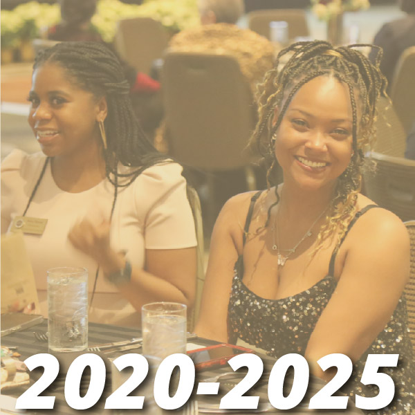 Timeline from 2020-2025, image shows two adult female medical students sitting at a table smiling with water glasses and silverware on the table getting ready for what appears to be a banquet setting. 