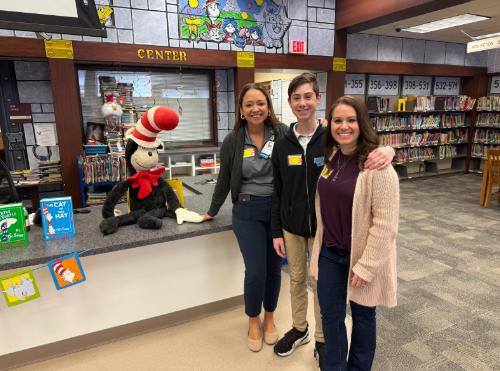 Residents with a student in a library