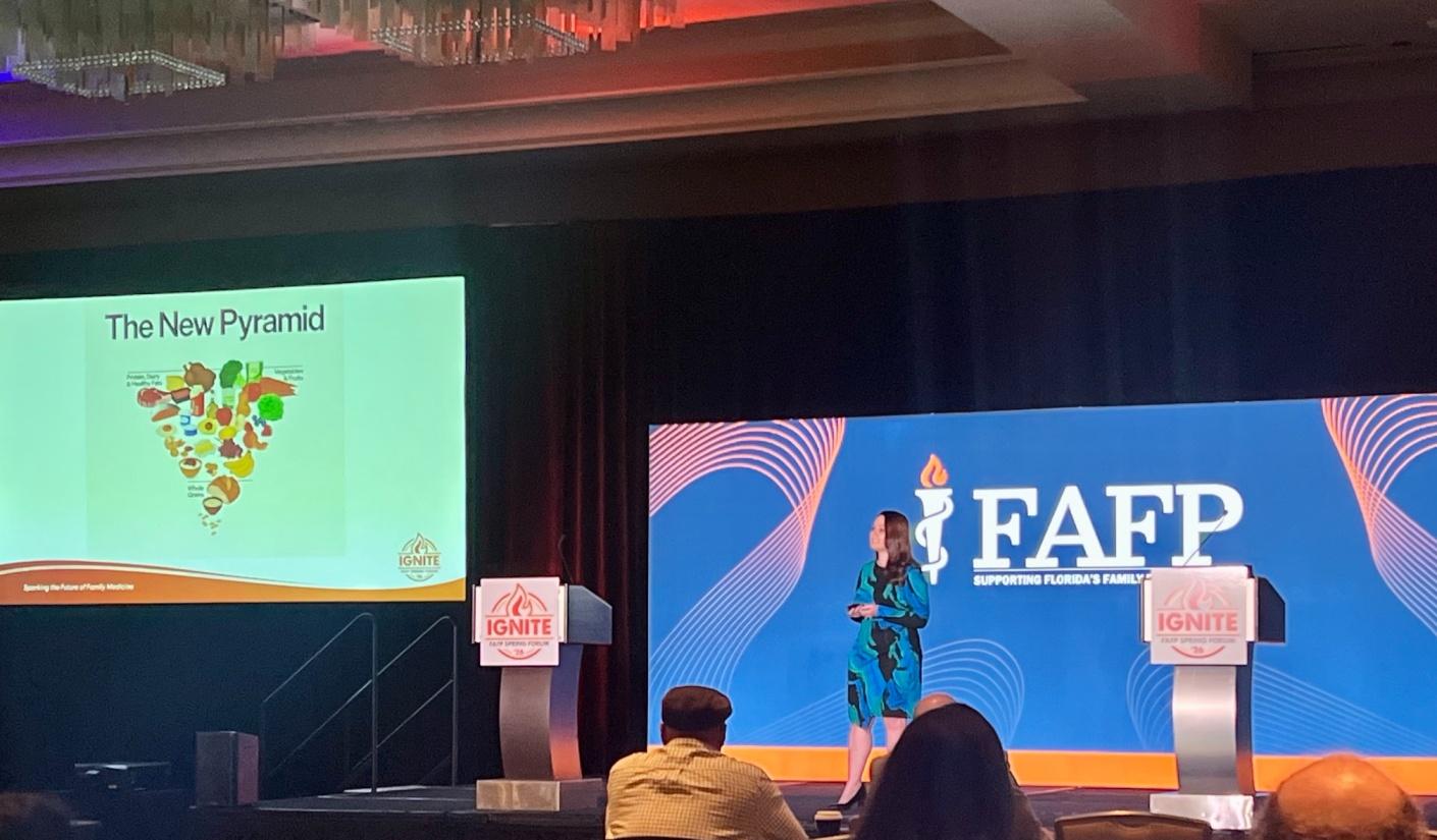 A residentpresenting a powerpoint at a conference