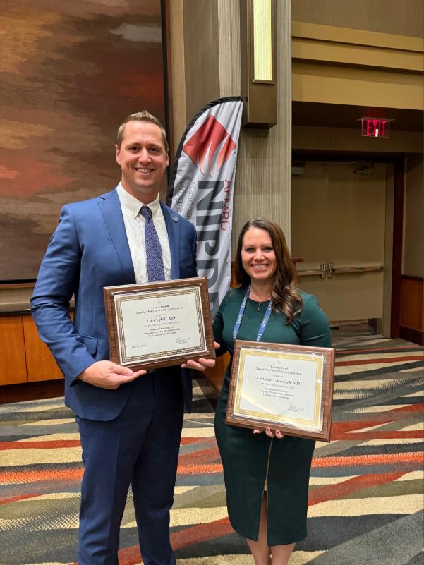 Dr. Cavanagh and an associate holding awards
