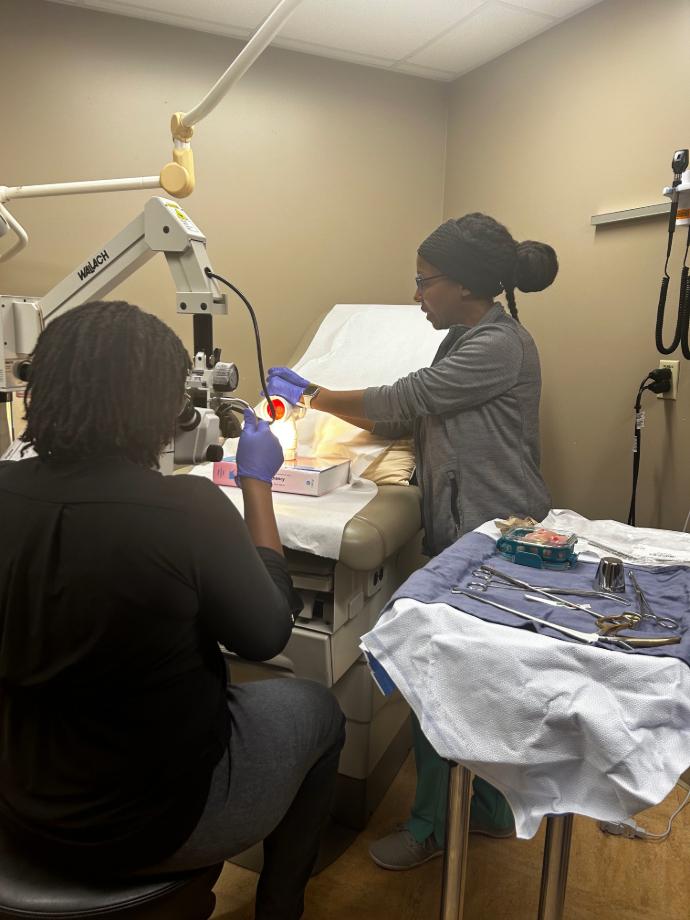 A female resident practices a procedure