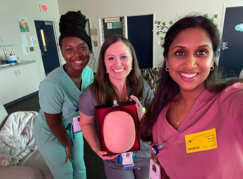 Selfie of three female residents in colorful scrubs