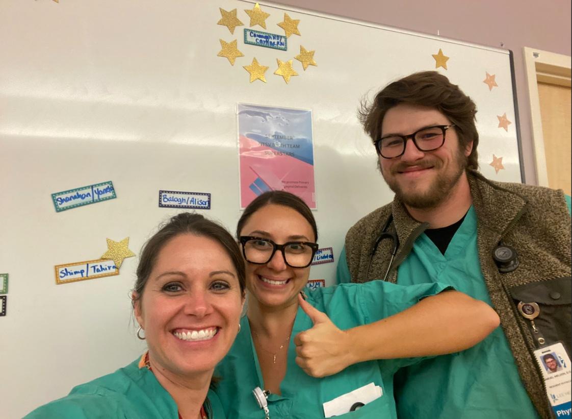 Two female residents and a male resident taking a selfie