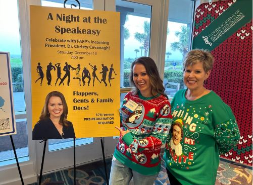Dr. Cavanagh and an associate pose in front of a poster