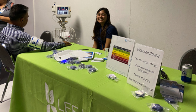 FSU faculty sitting at a 'Meet the Doctor' booth at an event